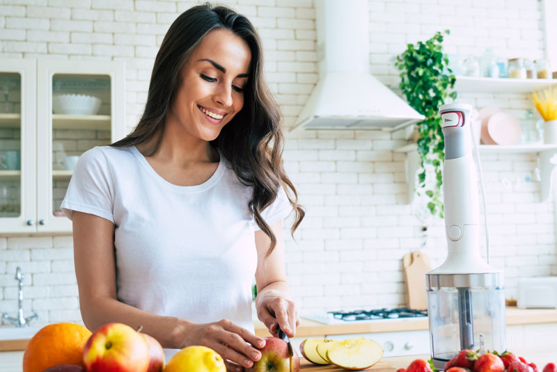 smile makeover patient cutting food to eat after recovery