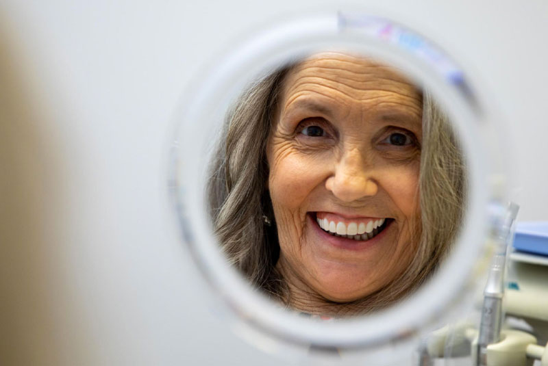 implant patient smiling after implants placed
