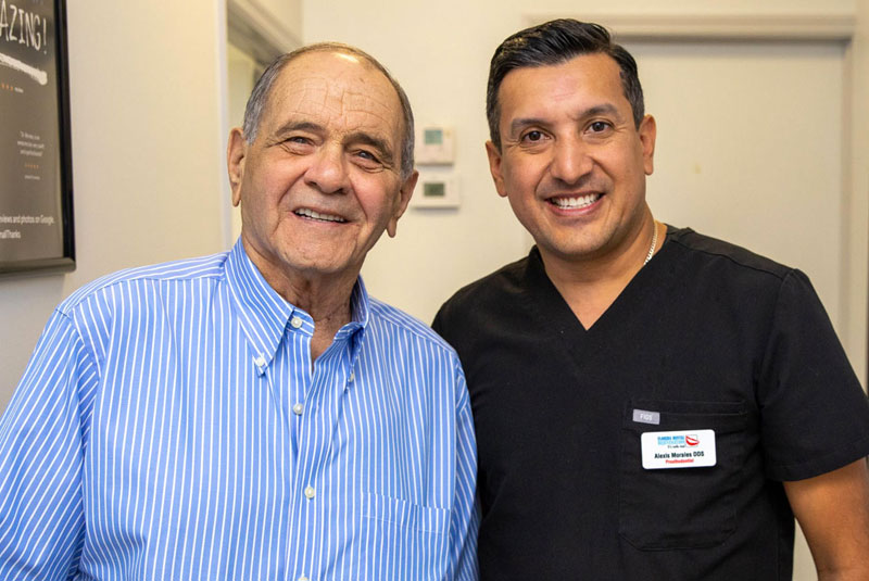Dr. Alexis Morales Posing And Smiling With Gary, A Dental Implant Patient, After His Full Arch Procedure