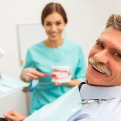 Very nice patient smiling with doctor behind him