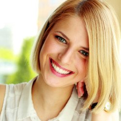 Very nice lady with blonde hair smiling looking forward